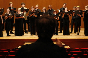 Photograph of Bram preparing a choir for performance.