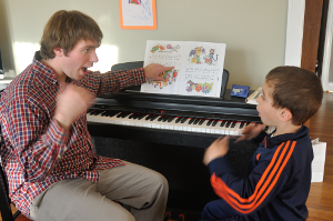 Photograph of Bram helping a young student through kinesthetic learning techniques.